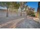 Large backyard with gravel, trees, and a small patio area at 1894 Wallingford St, Henderson, NV 89052