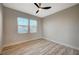 Well-lit bedroom featuring wood-look floors and two large windows at 1894 Wallingford St, Henderson, NV 89052