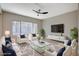 Virtually staged living room featuring comfy seating and a large TV at 1894 Wallingford St, Henderson, NV 89052