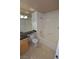 Bright bathroom featuring a tub-shower combo, vanity with dark countertop, and neutral tile flooring at 270 E Flamingo Rd # 211, Las Vegas, NV 89169