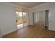 This bedroom features hardwood floors, balcony access, and mirrored closet at 270 E Flamingo Rd # 211, Las Vegas, NV 89169