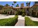 Inviting walkway to building with dual staircases, lush foliage, and manicured landscape at 270 E Flamingo Rd # 211, Las Vegas, NV 89169