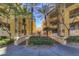The building featuring a courtyard entrance with mature trees and a welcoming pathway for residents at 270 E Flamingo Rd # 211, Las Vegas, NV 89169