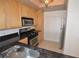 Charming kitchen featuring stainless appliances, granite countertops, and natural wood cabinets at 270 E Flamingo Rd # 211, Las Vegas, NV 89169