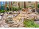 Scenic waterfall feature amidst rock formations and lush greenery, providing a tranquil and relaxing atmosphere at 270 E Flamingo Rd # 211, Las Vegas, NV 89169