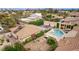 Aerial view of a home with a pool, hot tub, fire pit and basketball court in a spacious landscaped backyard at 2730 El Camino Rd, Las Vegas, NV 89146