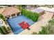 An aerial view of the backyard, featuring a basketball court and covered patio at 2730 El Camino Rd, Las Vegas, NV 89146