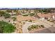 Wide aerial shot showcases a house with desert landscaping and palm trees with the city skyline in the distance at 2730 El Camino Rd, Las Vegas, NV 89146