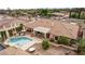 An aerial view of the backyard with a pool, spa, patio, and lush landscaping at 2730 El Camino Rd, Las Vegas, NV 89146
