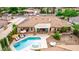 A captivating aerial view showcasing a sparkling pool, spa, and landscaped backyard with a charming covered patio at 2730 El Camino Rd, Las Vegas, NV 89146
