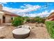 Private backyard featuring a round daybed, a small seating area, and lush greenery at 2730 El Camino Rd, Las Vegas, NV 89146