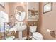 Bathroom featuring neutral walls, a pedestal sink, built in storage, a toilet, and decor at 2730 El Camino Rd, Las Vegas, NV 89146