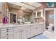 Bathroom with double vanity, white cabinets, tile counters and floors at 2730 El Camino Rd, Las Vegas, NV 89146