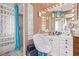 Bright bathroom features a glass block shower, vanity with lighted mirror, and a comfortable chair at 2730 El Camino Rd, Las Vegas, NV 89146