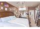 Bedroom featuring a ceiling fan, a bed with throw pillows and a view of the bathroom at 2730 El Camino Rd, Las Vegas, NV 89146