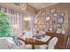 Inviting dining room with chandelier, dark wood table, and many framed wall decorations at 2730 El Camino Rd, Las Vegas, NV 89146