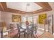 The dining room is decorated with a stylish light fixture, neutral walls, and tile floors at 2730 El Camino Rd, Las Vegas, NV 89146