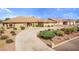Beautiful front exterior featuring a circular driveway and desert landscaping on a sunny day at 2730 El Camino Rd, Las Vegas, NV 89146