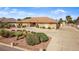 Charming single-story home featuring a well-manicured front yard with lush greenery and a paved driveway at 2730 El Camino Rd, Las Vegas, NV 89146