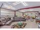 A spacious garage featuring a living area with leather seating, motorcycle, and classic car at 2730 El Camino Rd, Las Vegas, NV 89146