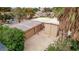 Aerial view of an oversized garage with multiple bays and ample parking space, nestled among lush greenery at 2730 El Camino Rd, Las Vegas, NV 89146