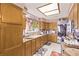 Functional kitchen with oak cabinets, tile flooring, and stainless steel appliances at 2730 El Camino Rd, Las Vegas, NV 89146