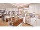 Bright kitchen with custom white cabinetry, stainless steel appliances, and an island centerpiece at 2730 El Camino Rd, Las Vegas, NV 89146