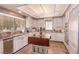 Charming kitchen featuring an island, custom cabinetry, and stainless steel appliances at 2730 El Camino Rd, Las Vegas, NV 89146