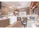 Well-lit laundry room with washer, dryer, ample counter space, storage cabinets, and a desk area at 2730 El Camino Rd, Las Vegas, NV 89146