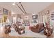 Spacious living room featuring plush leather seating, a brick fireplace, and stylish decor at 2730 El Camino Rd, Las Vegas, NV 89146