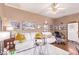 Comfortable living room with plush white sofa, ceiling fan, and decorative elements at 2730 El Camino Rd, Las Vegas, NV 89146