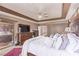 Sun-drenched primary bedroom features a large television and carpet floor at 2730 El Camino Rd, Las Vegas, NV 89146