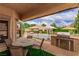 Outdoor patio with a built-in grill, a dining table, and views of the backyard pool at 2730 El Camino Rd, Las Vegas, NV 89146
