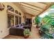 Covered patio area showcasing a comfortable seating arrangement, an outdoor rug, and tasteful plants at 2730 El Camino Rd, Las Vegas, NV 89146