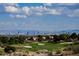 Stunning aerial view of a golf course with city skyline in the background at 3012 Anna Bay Dr, Las Vegas, NV 89134