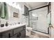 Bathroom with gray vanity, marble shower, and modern fixtures at 3012 Anna Bay Dr, Las Vegas, NV 89134