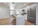 Modern kitchen with white cabinets, quartz countertops, and stainless steel appliances at 3012 Holly Hill Ave, Las Vegas, NV 89104