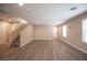 Open living room with staircase and wood-look floors at 3114 Leonetti Ct, Las Vegas, NV 89141