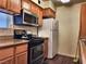 Kitchen with wood cabinets, gas stove, and refrigerator at 3318 N Decatur Blvd # 2068, Las Vegas, NV 89130