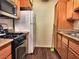 Kitchen with wood cabinets, gas stove, and refrigerator at 3318 N Decatur Blvd # 2068, Las Vegas, NV 89130