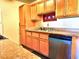 Kitchen with wood cabinets, granite countertops, and dishwasher at 3318 N Decatur Blvd # 2068, Las Vegas, NV 89130