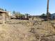 View of a backyard with sparse vegetation and fencing at 3748 Skyline St, Logandale, NV 89021