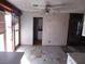 Dining area with damaged flooring and kitchen access at 3748 Skyline St, Logandale, NV 89021