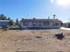 A one-story home on a large lot, featuring basic landscaping and desert surroundings at 3748 Skyline St, Logandale, NV 89021
