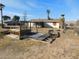 Back of house view with a damaged deck and hot tub at 3748 Skyline St, Logandale, NV 89021