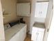 Functional laundry room with washer, dryer, and overhead cabinets at 3748 Skyline St, Logandale, NV 89021
