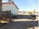 Side yard with broken fence and view of the street at 3748 Skyline St, Logandale, NV 89021