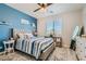 Bright bedroom with blue accent wall and striped bedding at 4104 Midnight Crest Ave, North Las Vegas, NV 89031