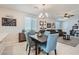 Open dining room with four chairs and view of living room at 4104 Midnight Crest Ave, North Las Vegas, NV 89031