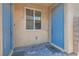 Front entry with blue door and brick flooring at 4104 Midnight Crest Ave, North Las Vegas, NV 89031